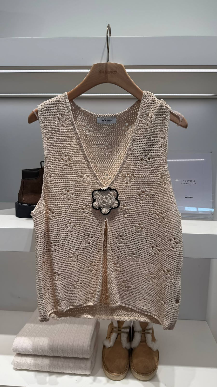 Crochet-style knit vest with flower brooch