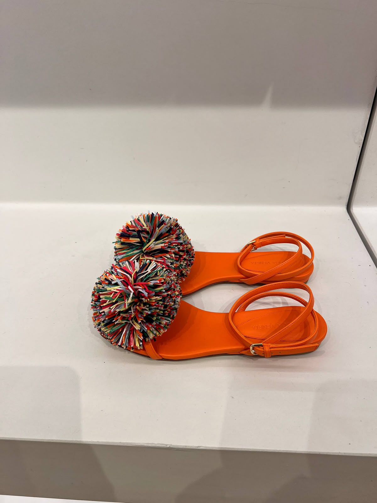 Pom-pom embellished leather sandals